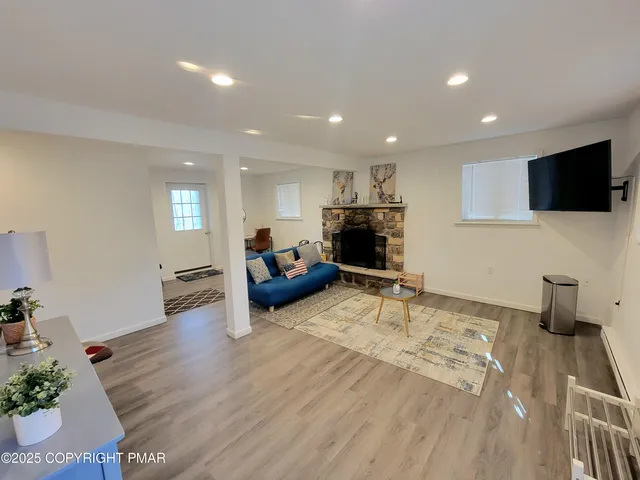 a living room with furniture and a flat screen tv