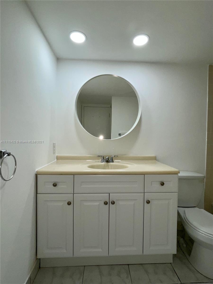 10802 Southwest 88th Street, Unit P2 Miami, FL 33176 - Photo 9 of 23 a bathroom with a sink and a mirror