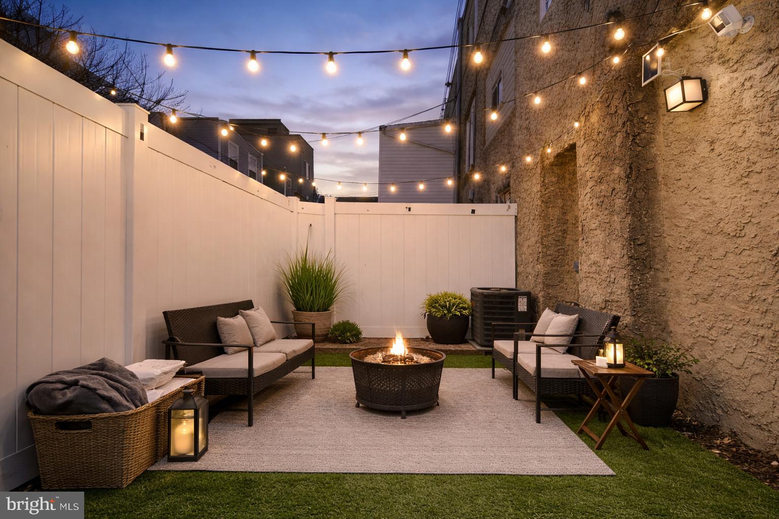 1607 South 28th Street Philadelphia, PA 19145 - Photo 11 of 11 Cozy outdoor retreat under twinkling lights.
