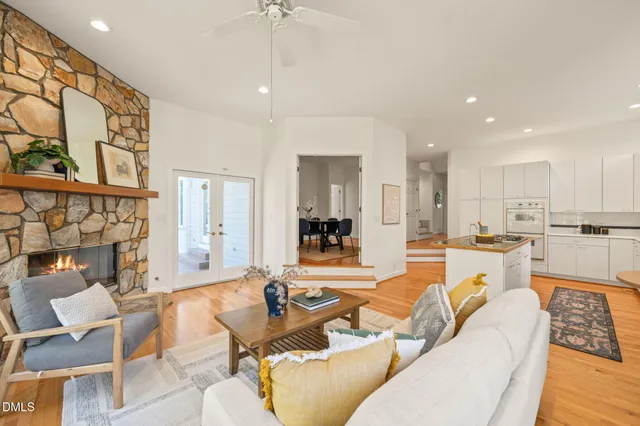 a kitchen with stainless steel appliances kitchen island granite countertop a sink and a refrigerator