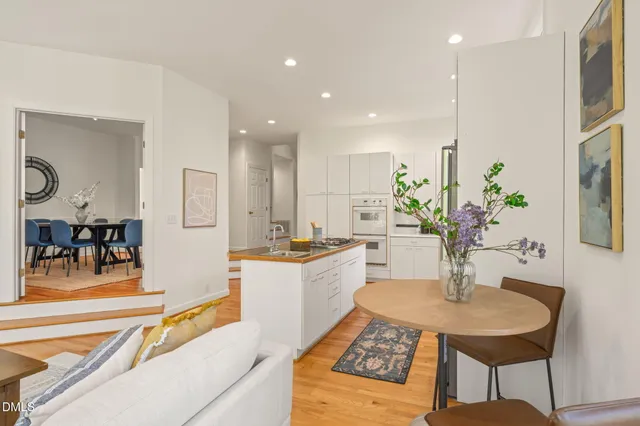 a large kitchen with stainless steel appliances granite countertop a refrigerator a sink and a stove