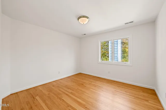 a view of a room with wooden floor and wall