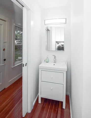 a bathroom with a sink mirror and vanity