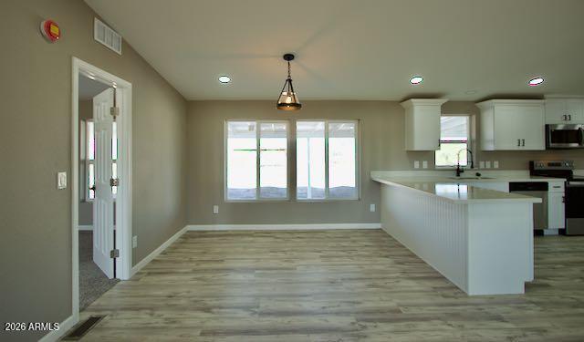 1470 South Bowman Road Apache Junction, AZ 85119 - Photo 20 of 56 a large kitchen with kitchen island a sink stainless steel appliances and window