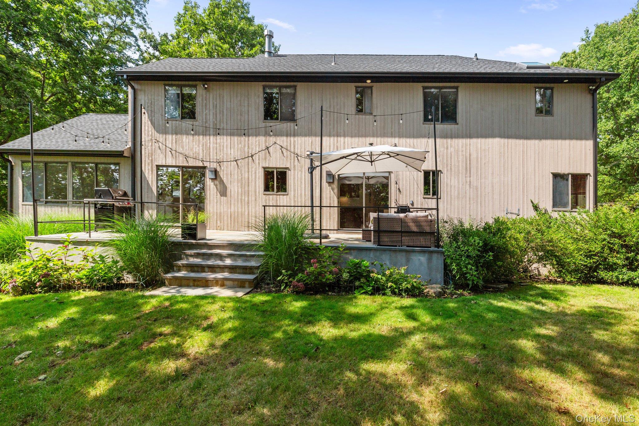 27 Stone Cabin Road New Rochelle, NY 10801 - Photo 19 of 24 Rear view of house with a deck and a lawn