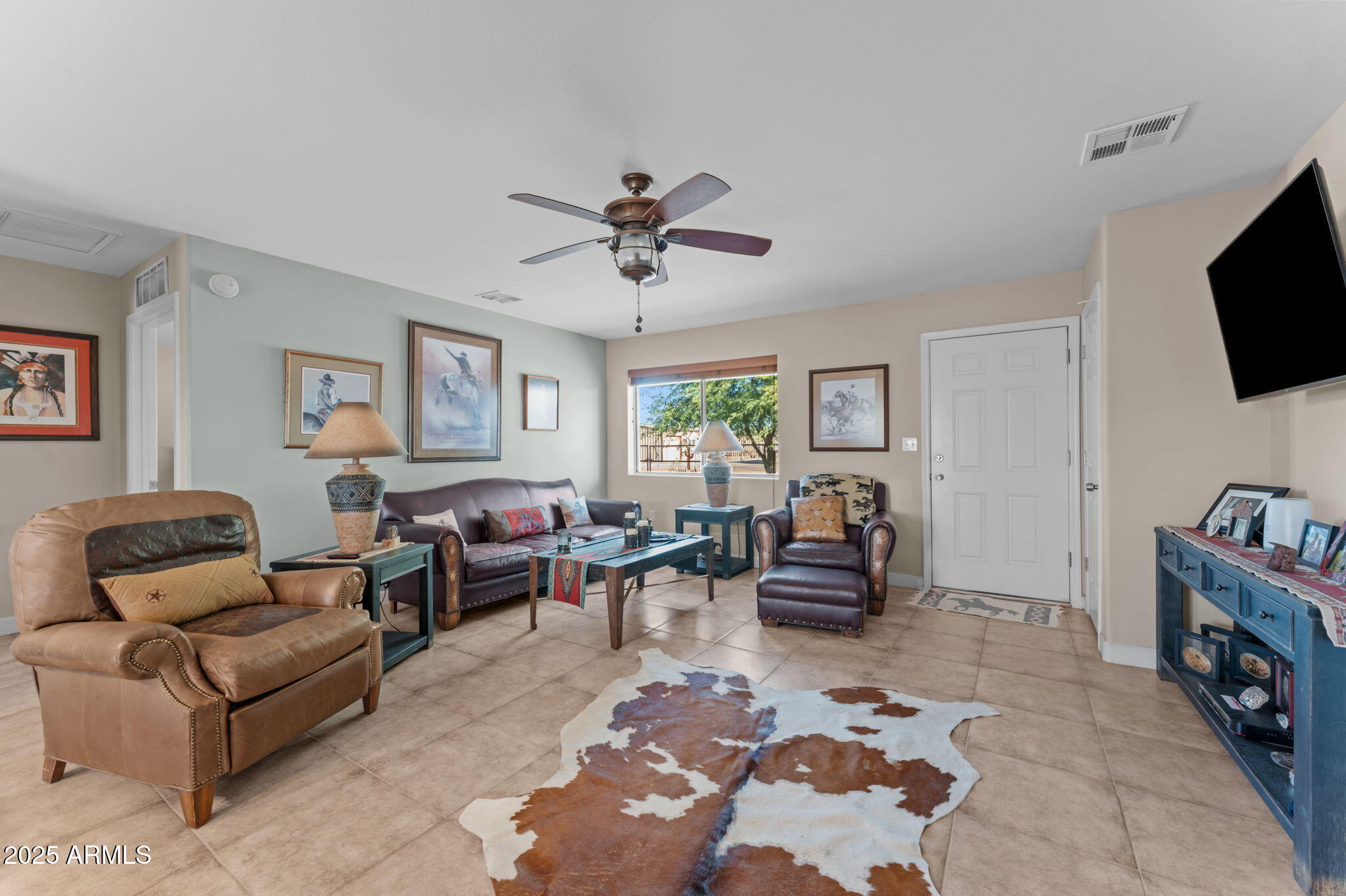 22309 West Rancho Caliente Wittmann, AZ 85361 - Photo 3 of 44 a living room with furniture and a flat screen tv