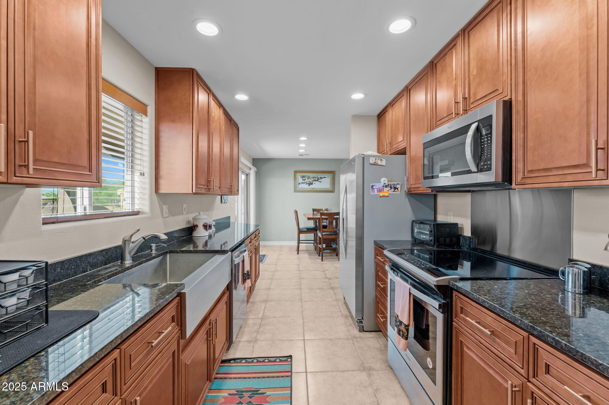22309 West Rancho Caliente Wittmann, AZ 85361 - Photo 4 of 44 a kitchen with granite countertop a sink a stove and cabinets