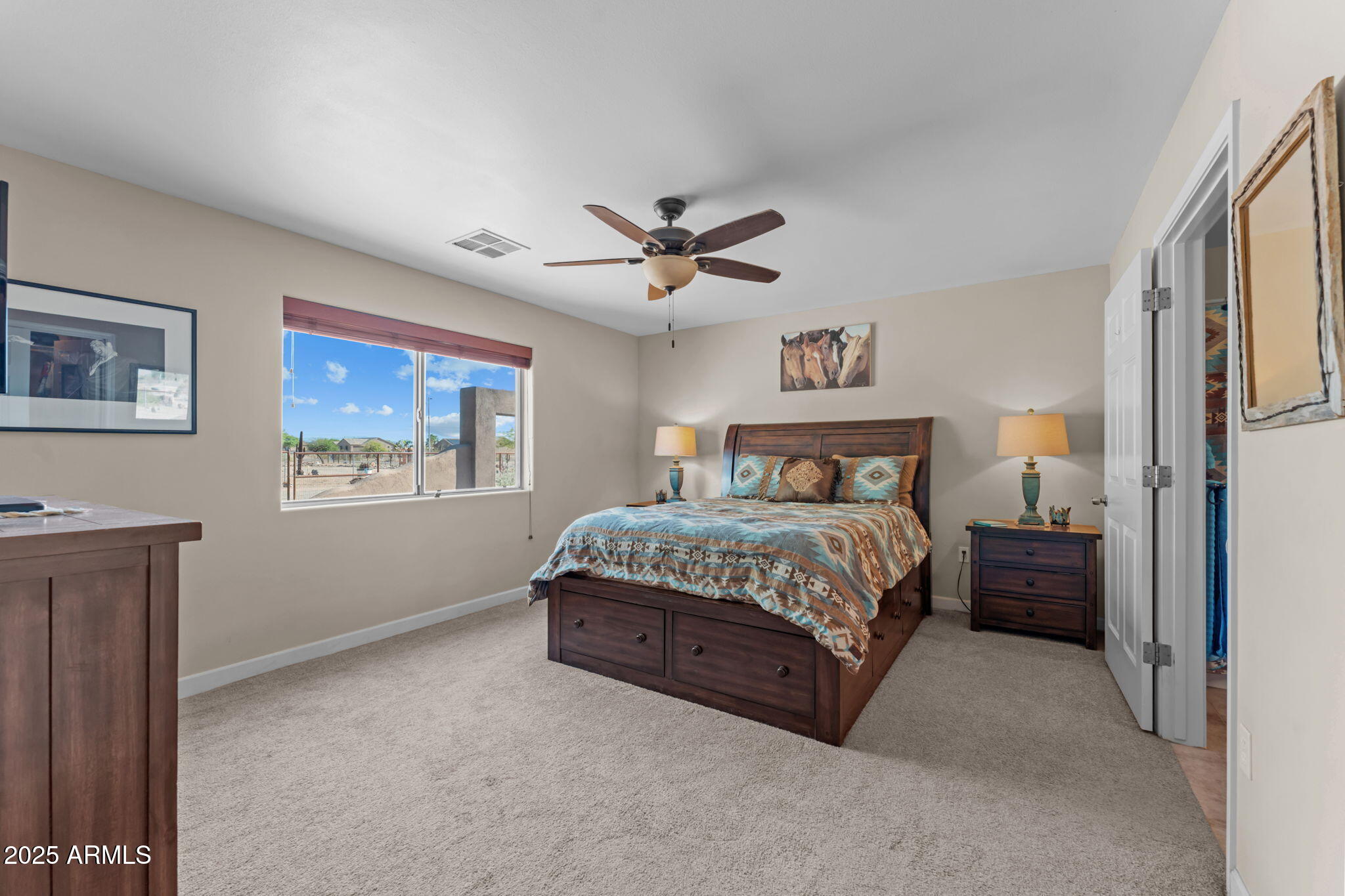22309 West Rancho Caliente Wittmann, AZ 85361 - Photo 8 of 44 a bedroom with a bed and a ceiling fan