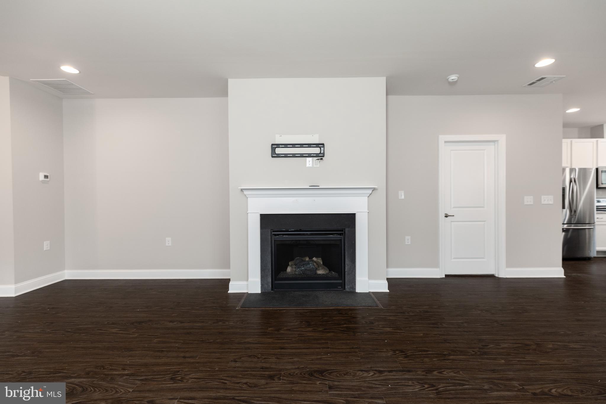1415 Whispering Woods Road Middletown, DE 19709 - Photo 13 of 42 a living room with a fireplace