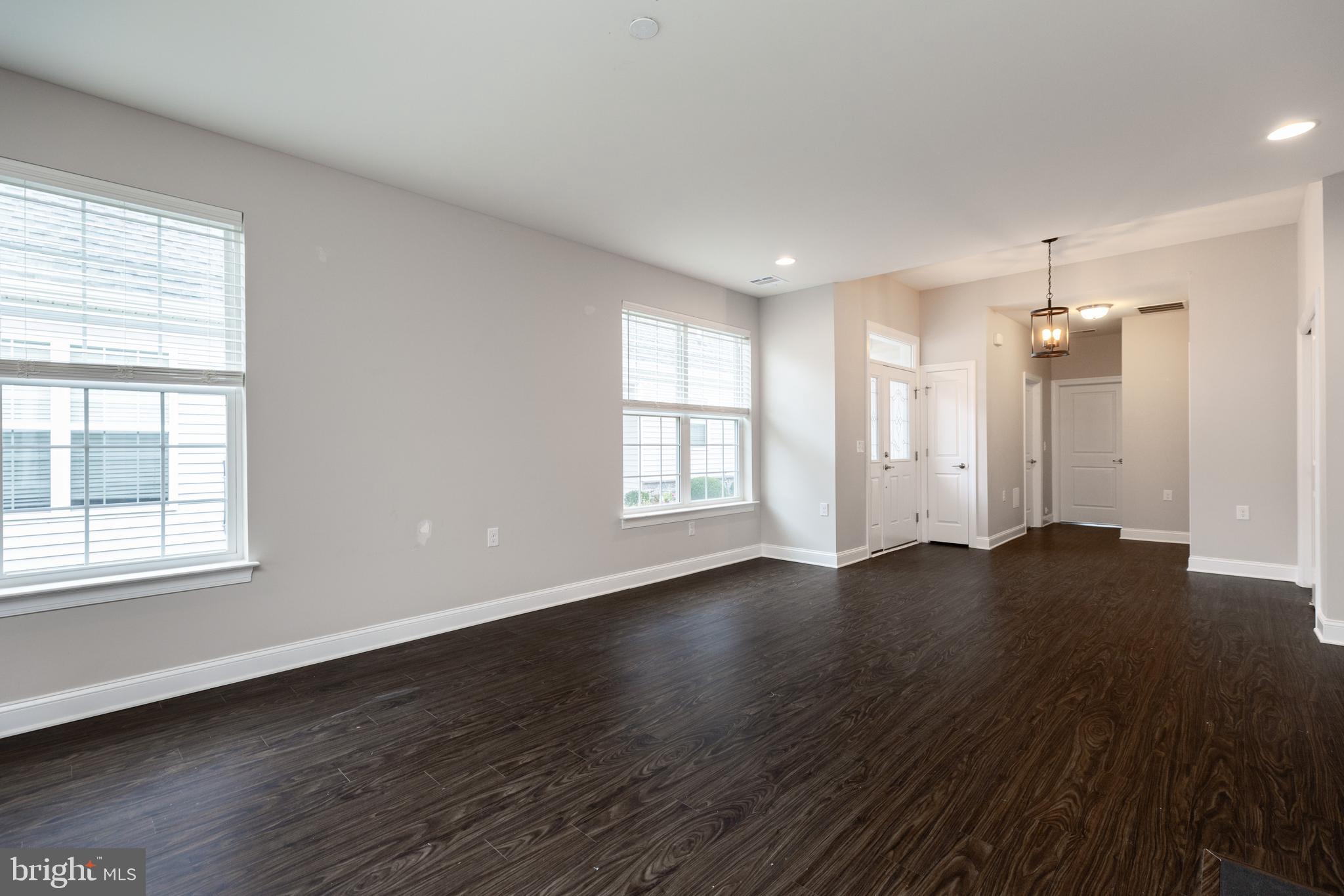 1415 Whispering Woods Road Middletown, DE 19709 - Photo 15 of 42 an empty room with wooden floor and windows