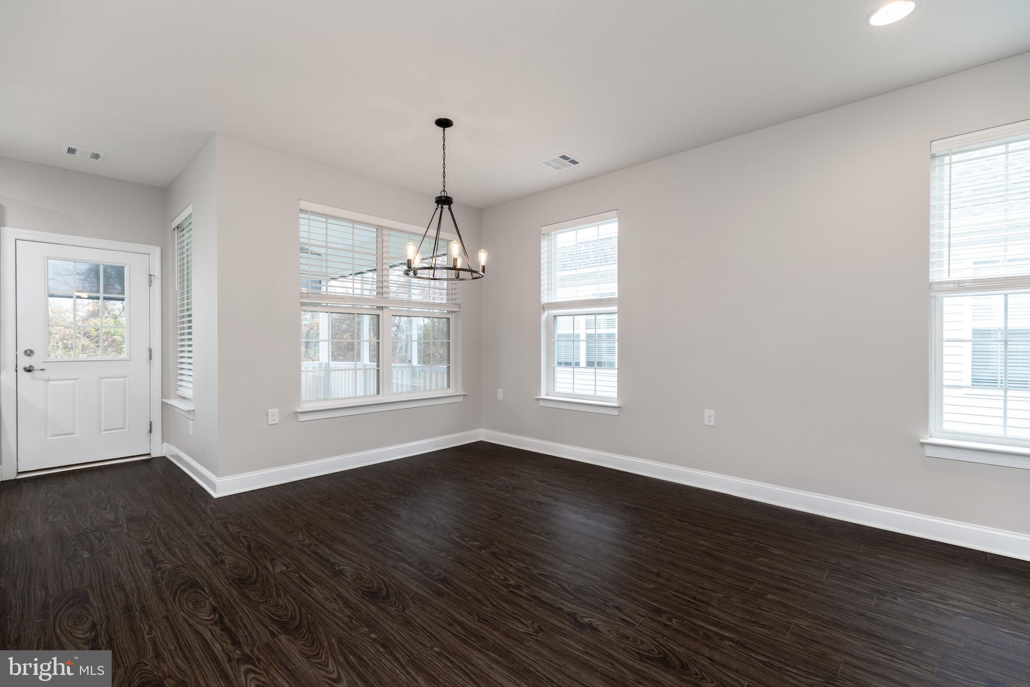 1415 Whispering Woods Road Middletown, DE 19709 - Photo 16 of 42 a view of an empty room with wooden floor and a window