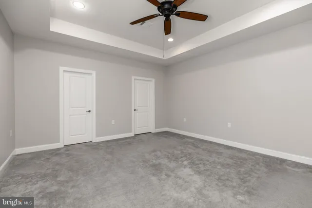 an empty room and chandelier fan