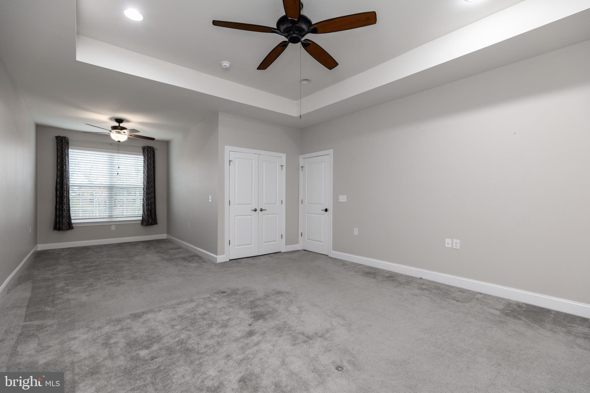 1415 Whispering Woods Road Middletown, DE 19709 - Photo 27 of 42 an empty room with windows and fan
