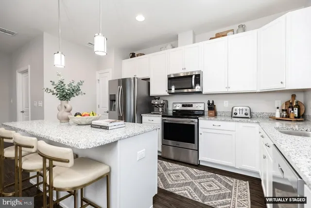 a living room with furniture a fireplace and a large window