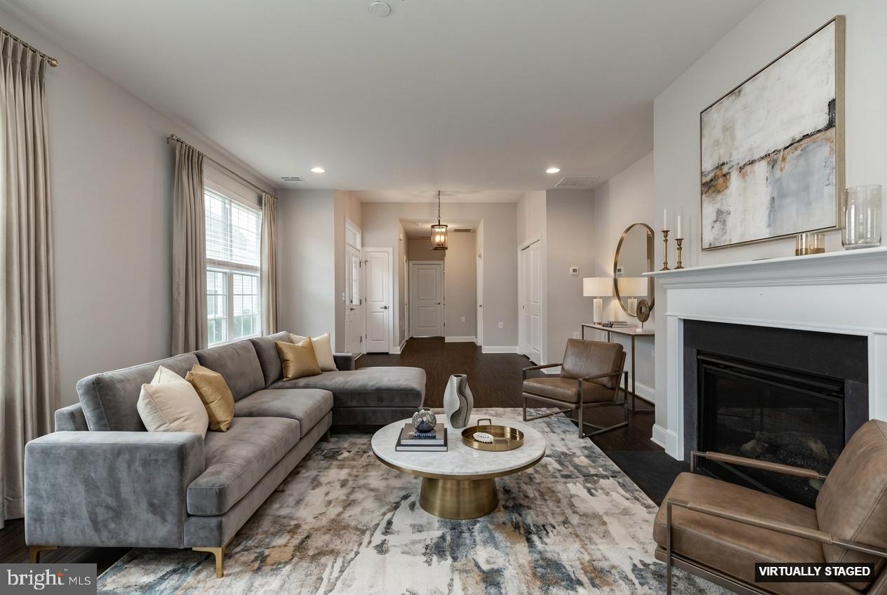 1415 Whispering Woods Road Middletown, DE 19709 - Photo 4 of 42 a living room with furniture a fireplace and a large window