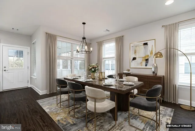 a spacious bedroom with a bed a couch and potted plant with the potted plants