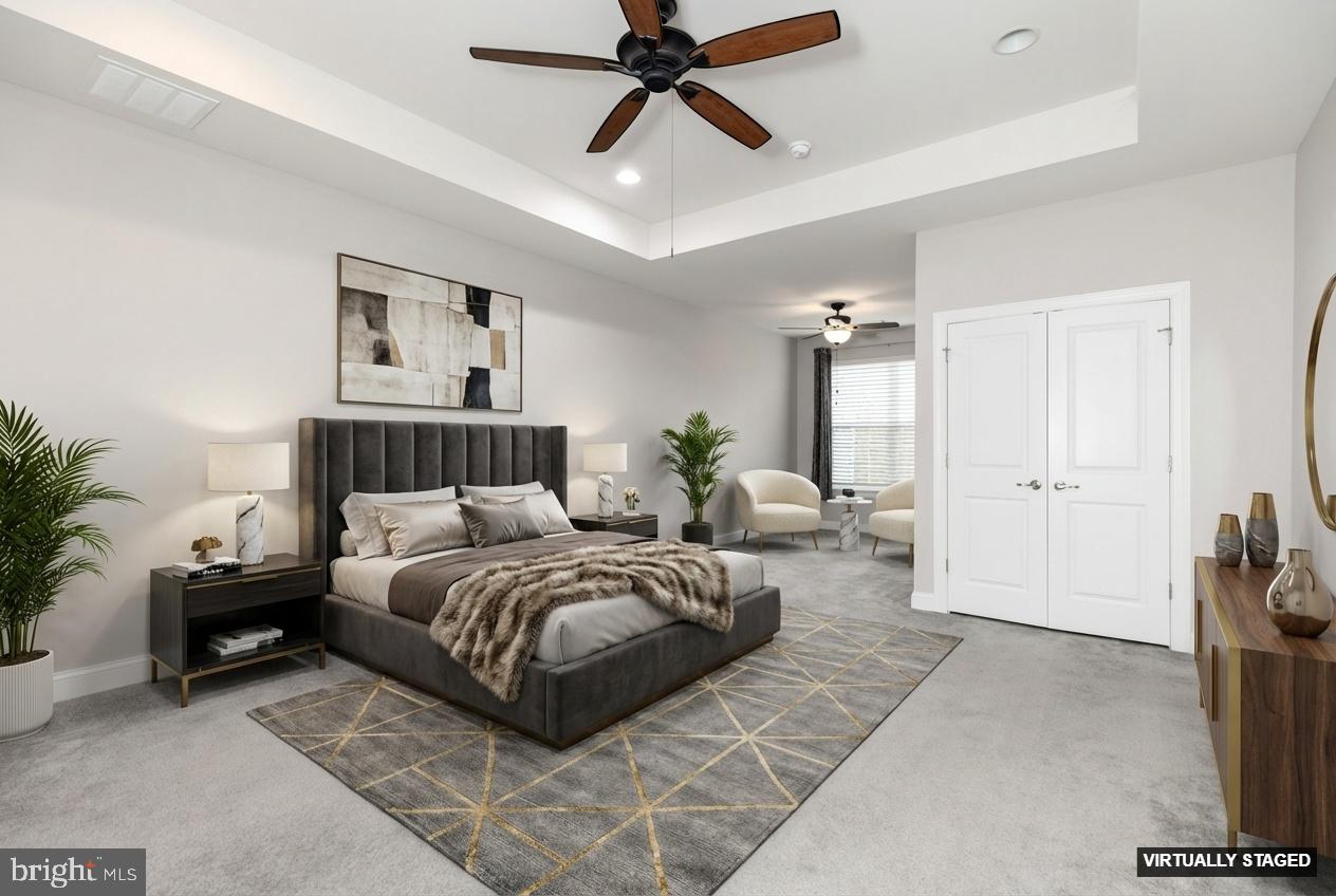 1415 Whispering Woods Road Middletown, DE 19709 - Photo 6 of 42 a spacious bedroom with a bed a couch and potted plant with the potted plants