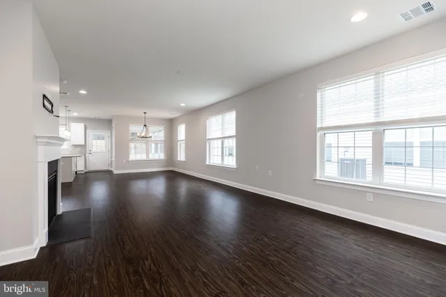 a view of a room with wooden floor and window