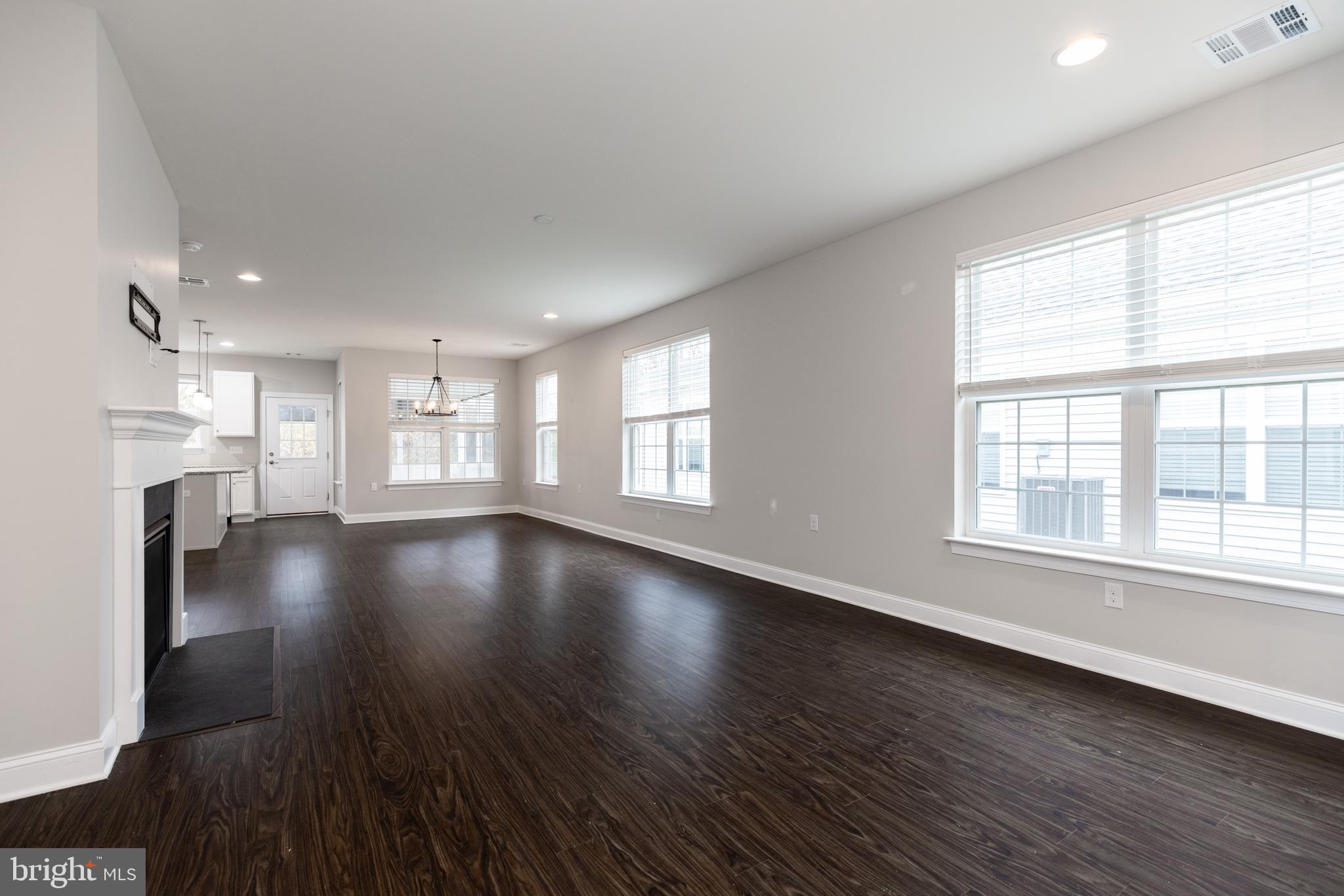 1415 Whispering Woods Road Middletown, DE 19709 - Photo 10 of 42 a view of an empty room with wooden floor and a window