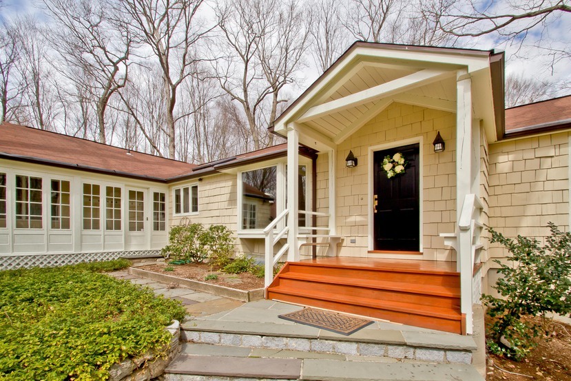 1039 Valley Road New Canaan, CT 06840 - Photo 3 of 17 a front view of a house with a garden