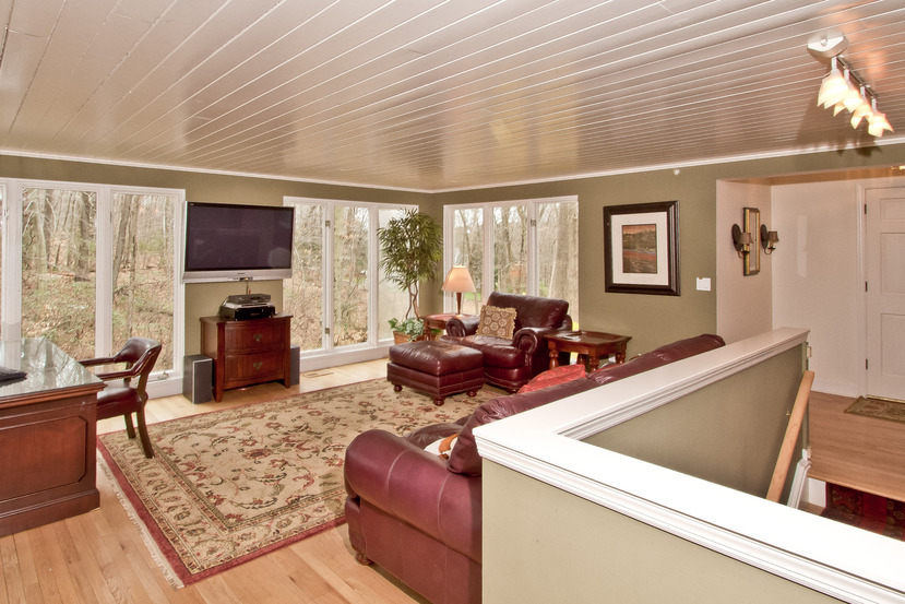 1039 Valley Road New Canaan, CT 06840 - Photo 4 of 17 a living room with furniture a flat screen tv and a large window