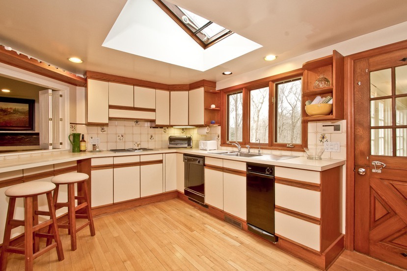 1039 Valley Road New Canaan, CT 06840 - Photo 8 of 17 a kitchen with stainless steel appliances granite countertop a stove top oven a sink dishwasher and white cabinets with wooden floor