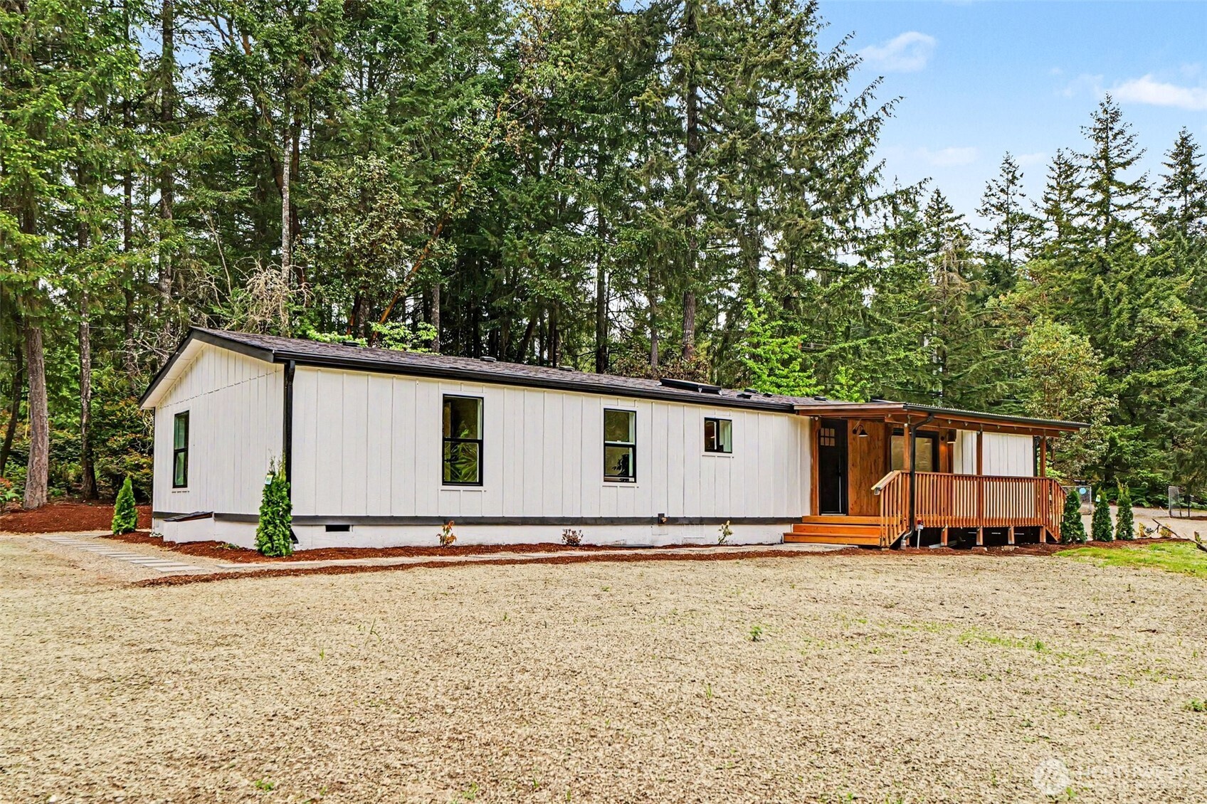 719 Tiedman Road Southwest Lakebay, WA 98349 - Photo 1 of 40 a view of a house with backyard and sitting area