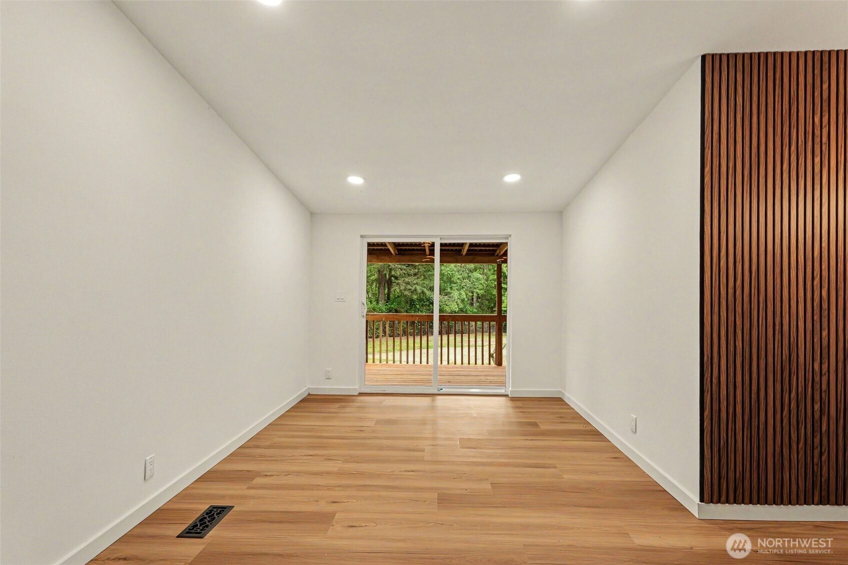 719 Tiedman Road Southwest Lakebay, WA 98349 - Photo 18 of 40 a view of an empty room with wooden floor and a window