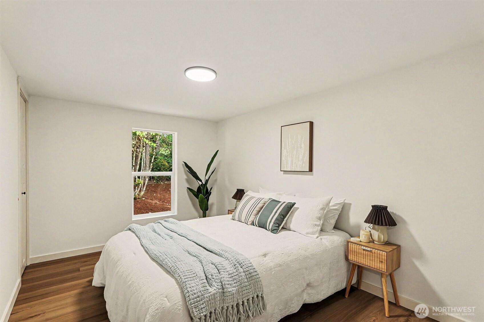719 Tiedman Road Southwest Lakebay, WA 98349 - Photo 21 of 40 a bedroom with a bed and a window
