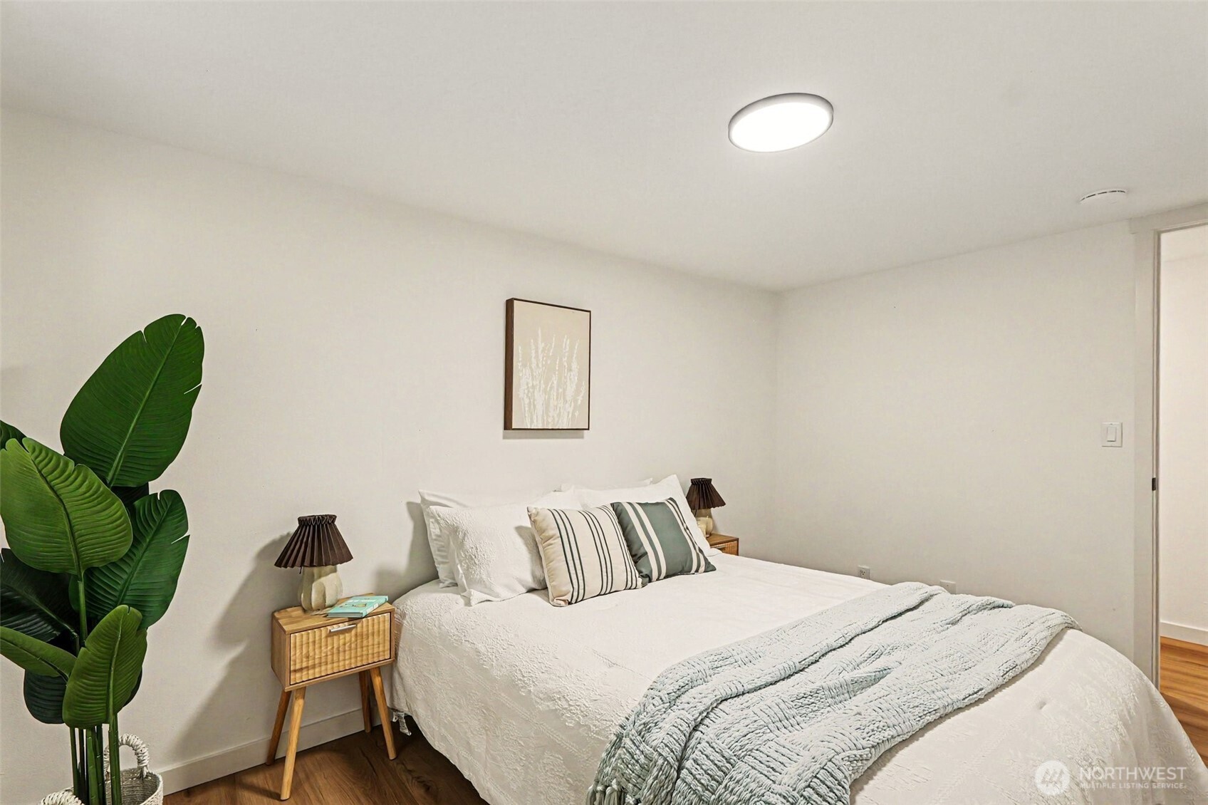 719 Tiedman Road Southwest Lakebay, WA 98349 - Photo 22 of 40 a bedroom with a bed with a potted plant