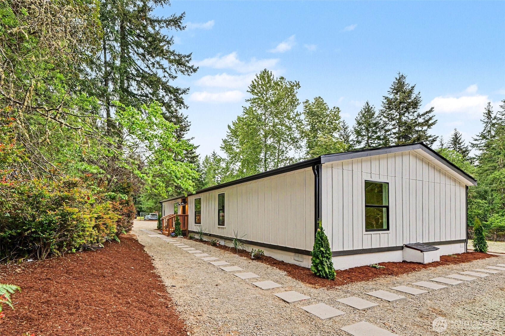719 Tiedman Road Southwest Lakebay, WA 98349 - Photo 34 of 40 a view of a house with backyard and trees