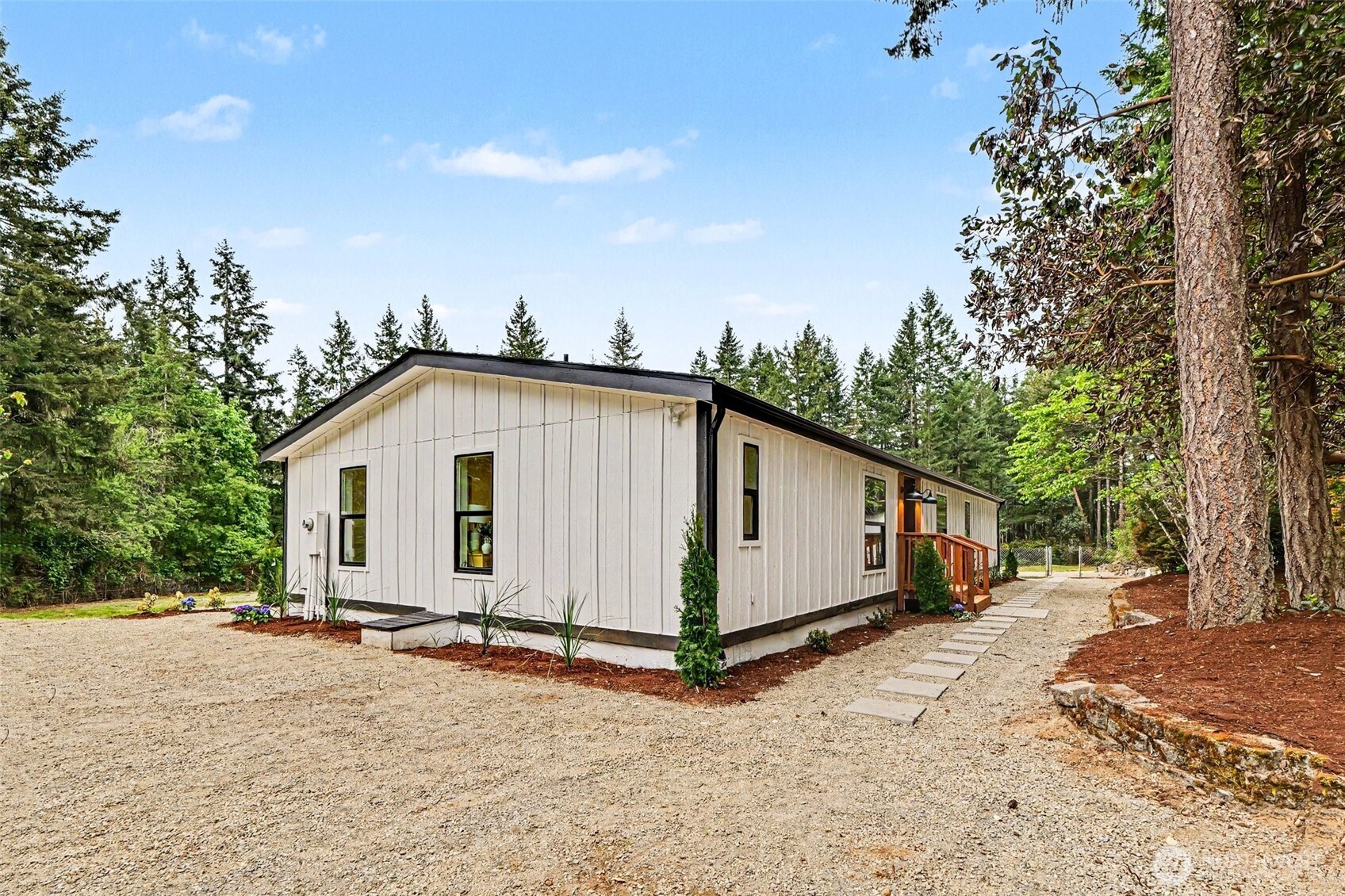 719 Tiedman Road Southwest Lakebay, WA 98349 - Photo 35 of 40 a view of a house with a yard and wooden fence