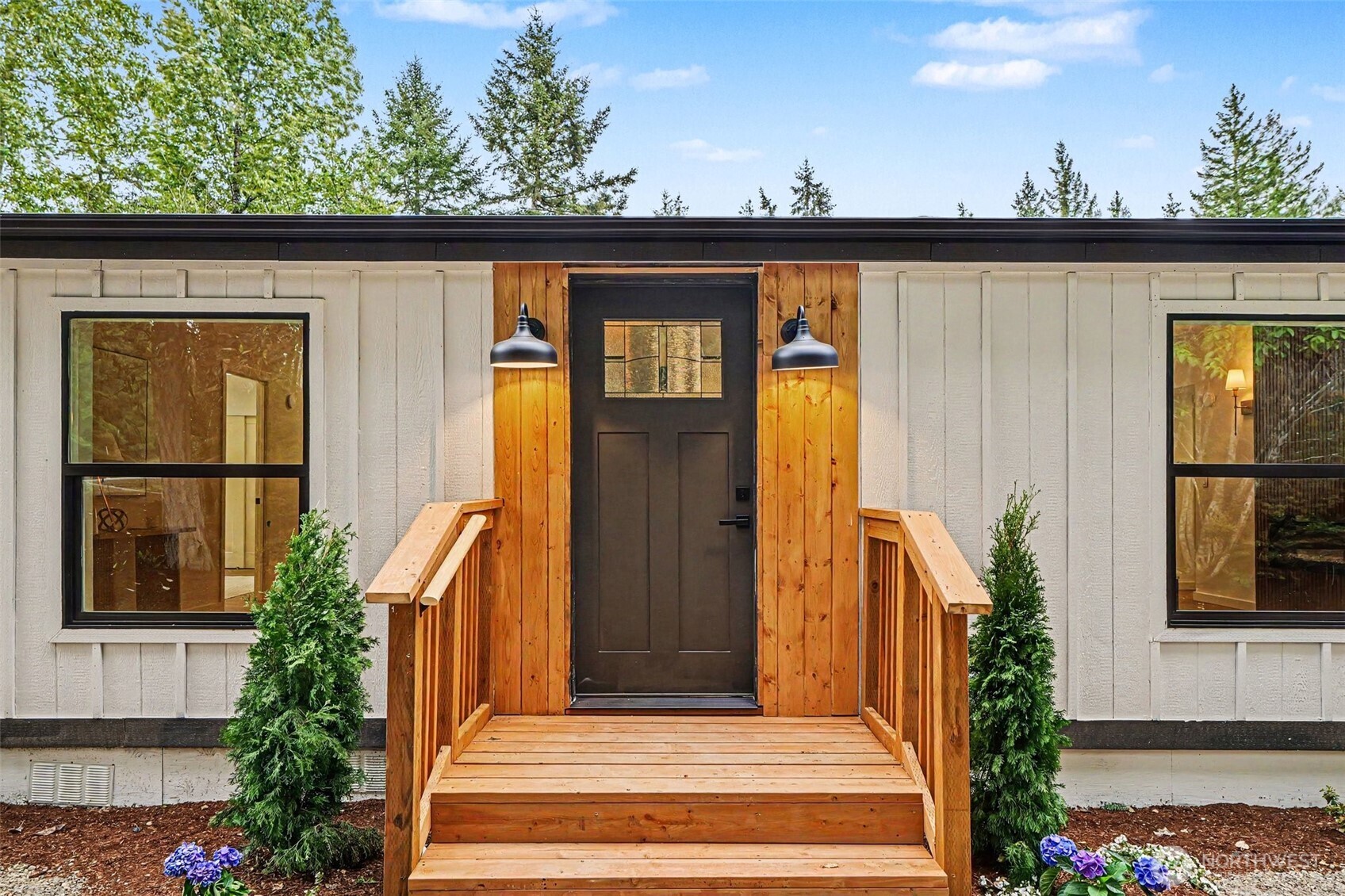 719 Tiedman Road Southwest Lakebay, WA 98349 - Photo 4 of 40 a front view of a house with a garden