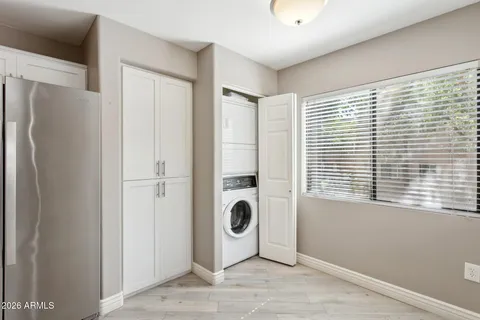 a view of a livingroom with a window and a refrigerator