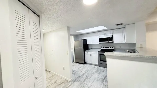a kitchen with a sink a stove and refrigerator