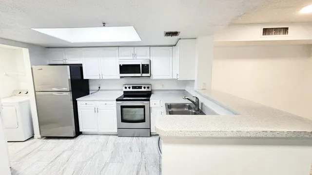 a kitchen with a refrigerator and a sink