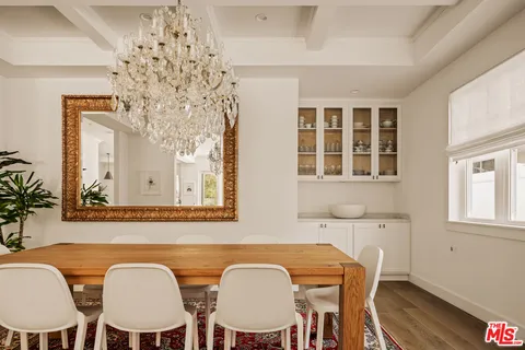 a view of a dining room with furniture and chandelier
