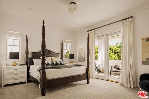a spacious bedroom with a bed and large window