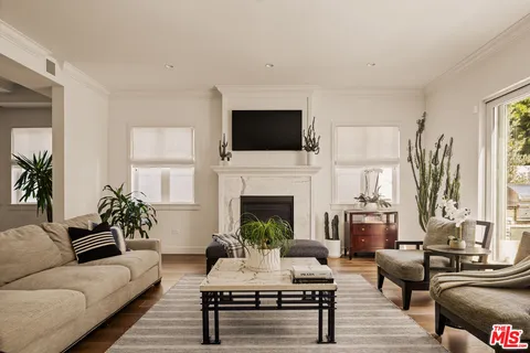 a living room with furniture fireplace and window