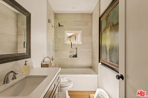 a bathroom with a sink a bathtub and a shower