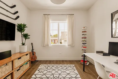 a bed room with a bed and a television