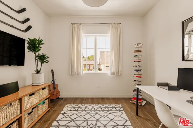 a bed room with a bed and a television