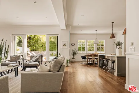 a living room with furniture and large windows