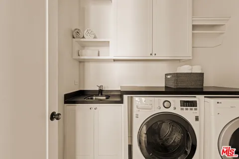 a kitchen with stainless steel appliances granite countertop a sink and a stove