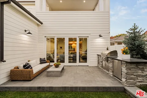 a view of a patio with couches and potted plants