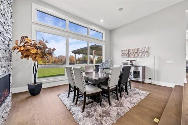 a dining room with furniture and wooden floor