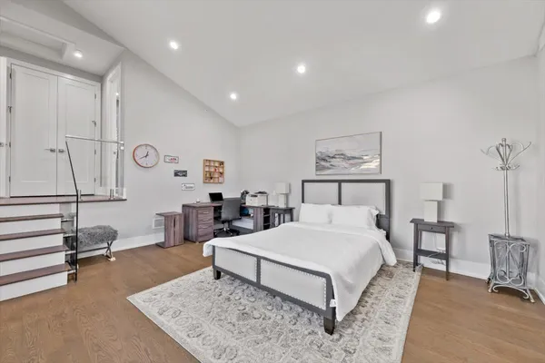 a bedroom with a large bed and a window