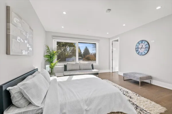 a bedroom with a large bed and a couch