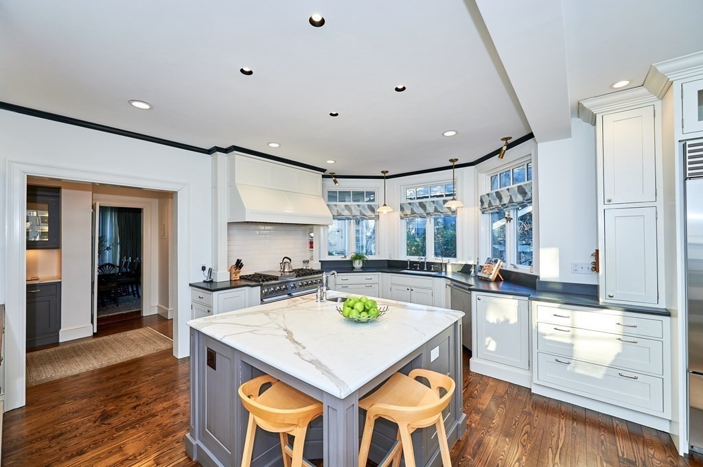 72 Pine Ridge Road Newton, MA 02468 - Photo 11 of 41 a kitchen with a stove a refrigerator and a dining table with wooden floor