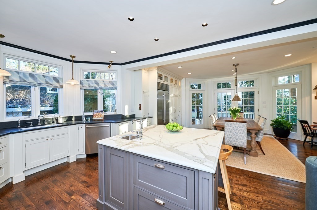 72 Pine Ridge Road Newton, MA 02468 - Photo 12 of 41 a view of a kitchen island a sink and living room with granite countertop furniture